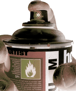 EDGE23 - Artist holding a spraypaint can at you, finger poised on paint spattered nozzle. with "ARTIST" showing on the label